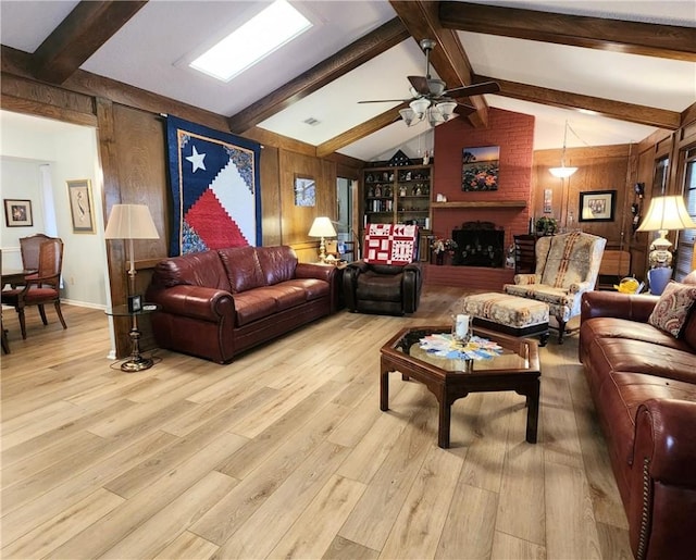 6421 Oakbrook Dr, Corpus Christi, TX 78413 - living room with a brick fireplace, wooden walls, ceiling fan, and light wood-style floors
