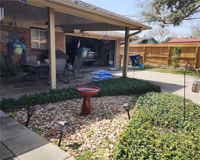 view of yard featuring fence and a patio