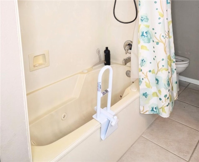 full bath featuring toilet, tile patterned flooring, and shower / tub combo with curtain