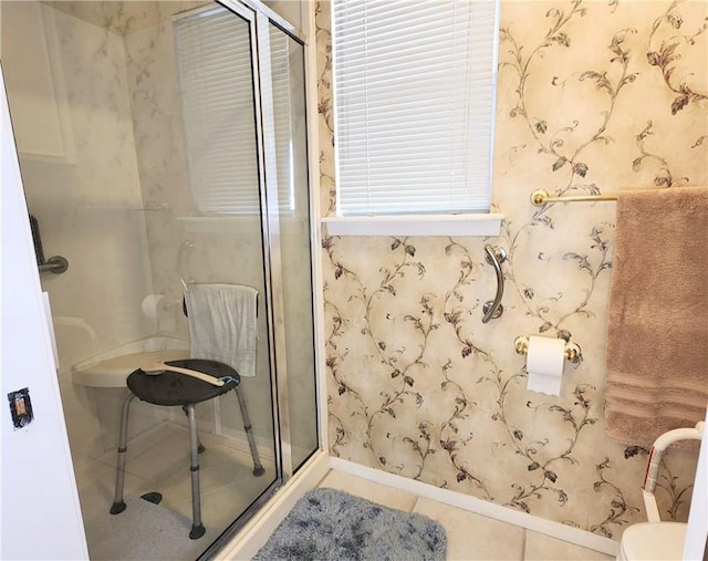 full bath with a stall shower, tile patterned flooring, toilet, and wallpapered walls