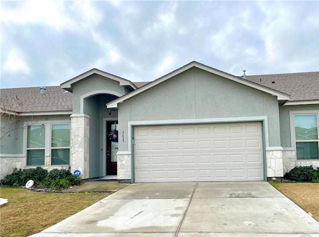 single story home featuring a garage and a front yard