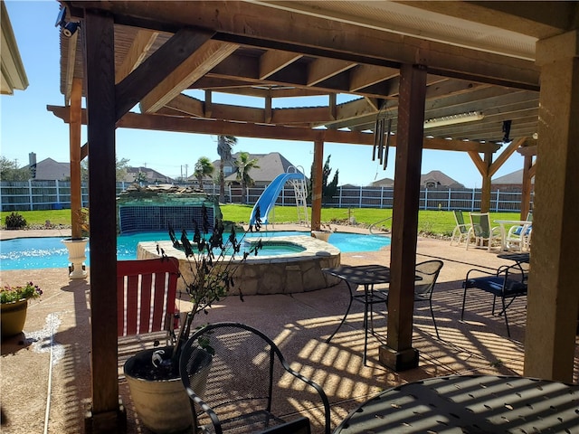 view of patio / terrace featuring a swimming pool with hot tub