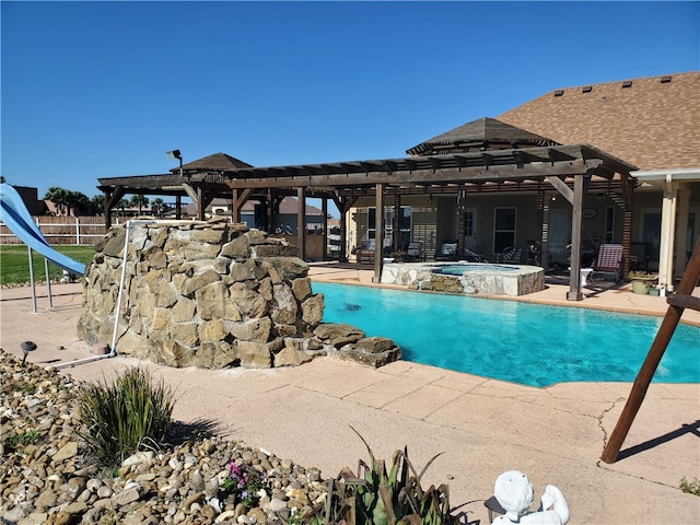 view of pool with a patio, an in ground hot tub, and a water slide