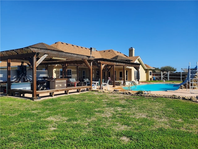 back of house featuring a yard, a pergola, a fenced in pool, and a patio area