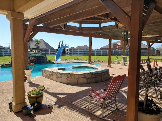 view of swimming pool with an in ground hot tub, a yard, a patio, and a water slide