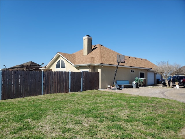 back of property featuring a lawn and a patio area