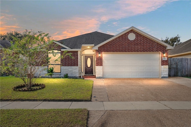 view of front facade featuring a garage and a lawn