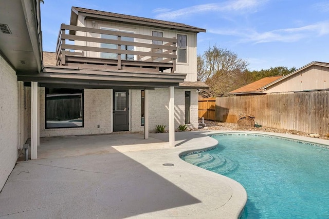 view of swimming pool featuring fence, a fenced in pool, and a patio