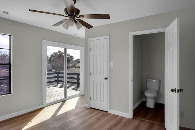 bedroom featuring access to outside, light hardwood / wood-style floors, and ensuite bathroom