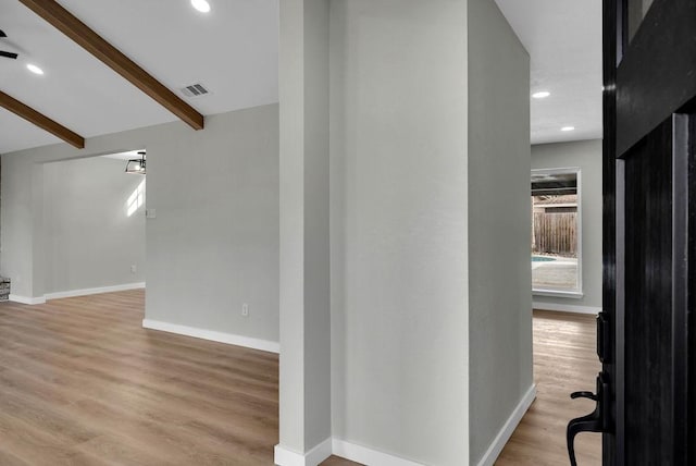 hall featuring recessed lighting, visible vents, baseboards, light wood-style floors, and beamed ceiling