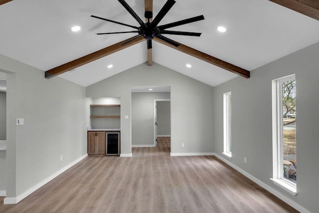 unfurnished living room featuring lofted ceiling with beams, ceiling fan, wine cooler, and light wood-type flooring