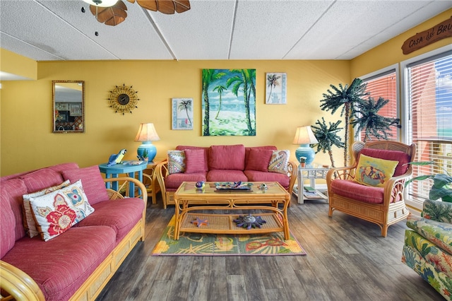 living room featuring ceiling fan, a textured ceiling, and dark hardwood / wood-style floors