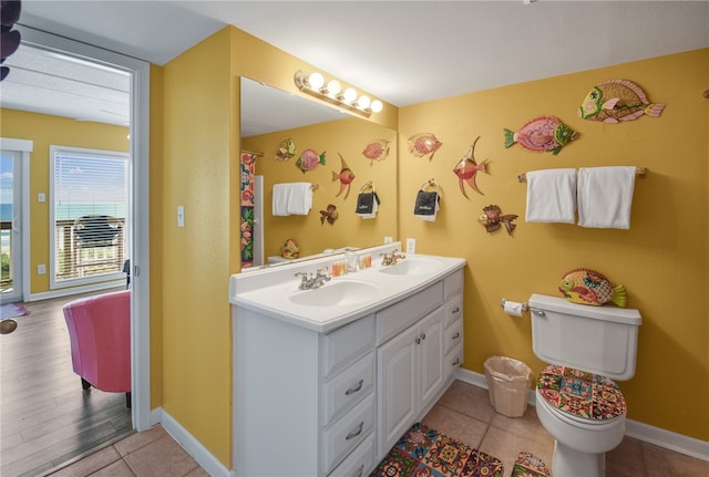 bathroom with wood-type flooring, vanity, and toilet