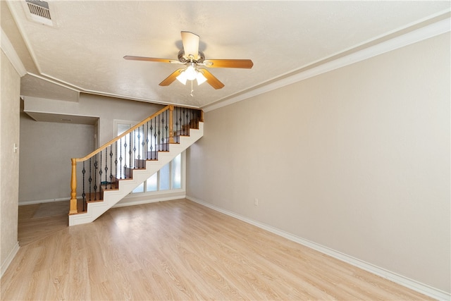 interior space with hardwood / wood-style floors, ceiling fan, a textured ceiling, and ornamental molding