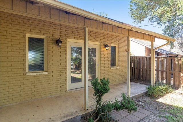 view of exterior entry featuring a patio area