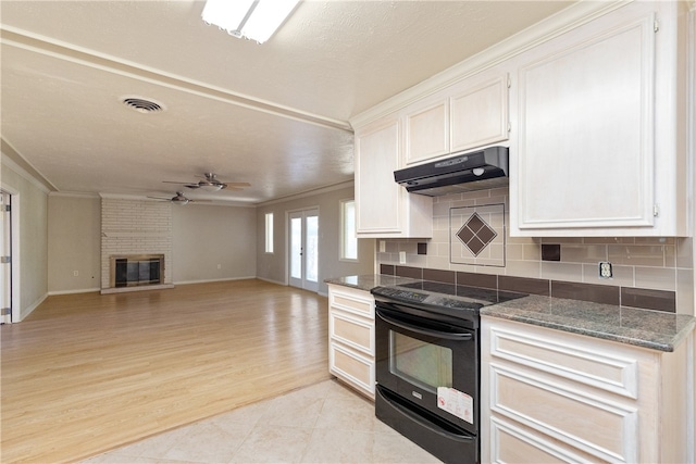 kitchen featuring light hardwood / wood-style floors, black range with electric stovetop, ceiling fan, white cabinetry, and a fireplace