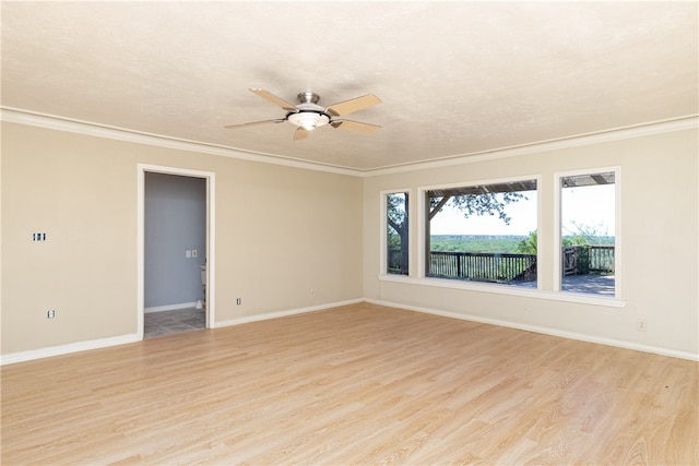 empty room with ornamental molding, ceiling fan, and light hardwood / wood-style floors