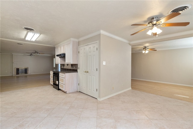 kitchen featuring white cabinetry, black range with electric stovetop, light wood-type flooring, and ornamental molding