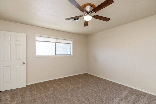 carpeted empty room featuring ceiling fan