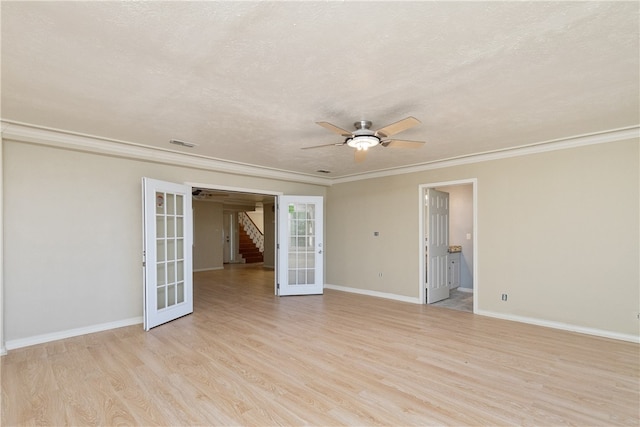 empty room with ornamental molding, ceiling fan, a textured ceiling, light hardwood / wood-style flooring, and french doors