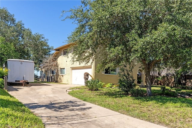 view of front of home featuring a garage and a front yard