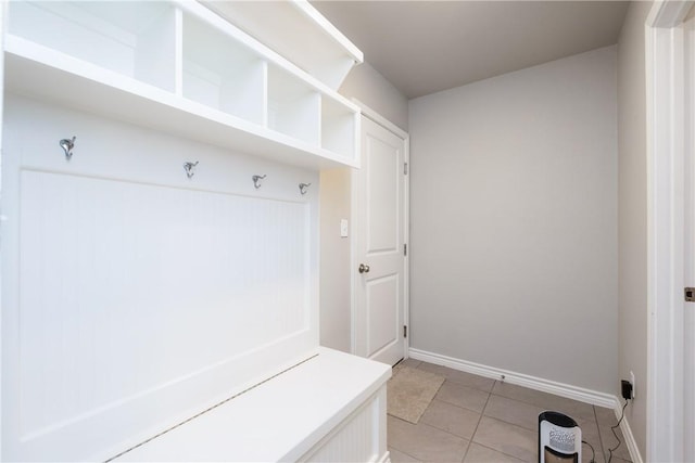 mudroom with light tile patterned floors and baseboards