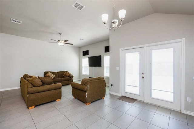 living room with lofted ceiling, light tile patterned floors, ceiling fan with notable chandelier, and visible vents