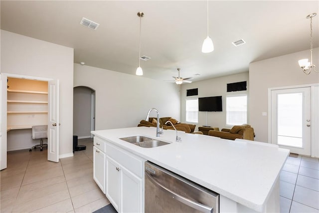 kitchen with a sink, visible vents, arched walkways, and dishwasher