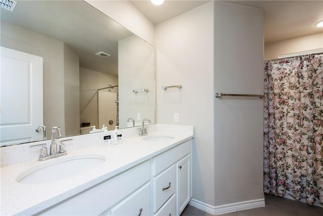 bathroom featuring a sink, visible vents, and double vanity