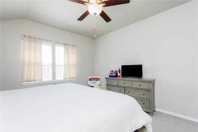 bedroom featuring baseboards, light carpet, lofted ceiling, and ceiling fan