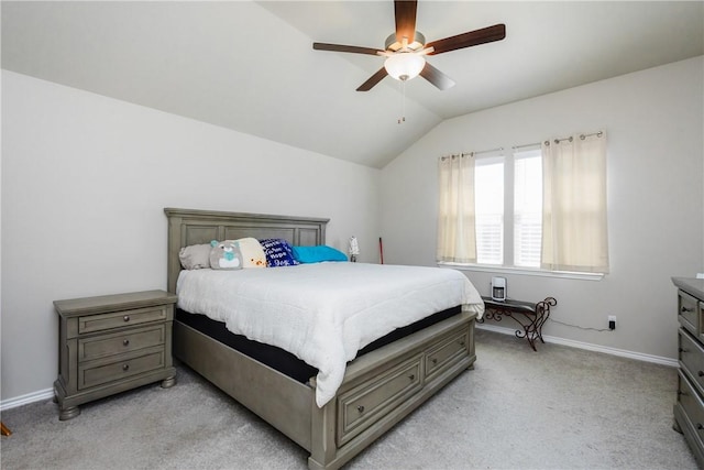 bedroom with a ceiling fan, vaulted ceiling, light colored carpet, and baseboards