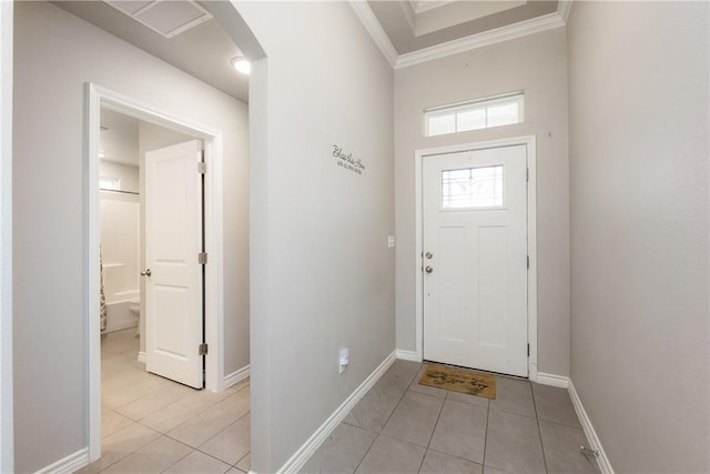 entrance foyer with crown molding, light tile patterned floors, arched walkways, and baseboards