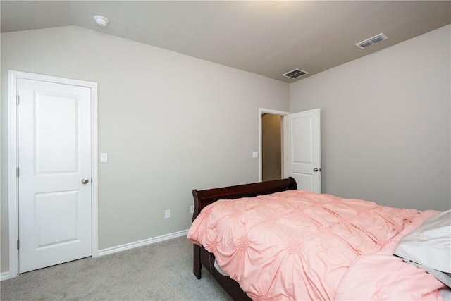 bedroom with vaulted ceiling, carpet flooring, baseboards, and visible vents