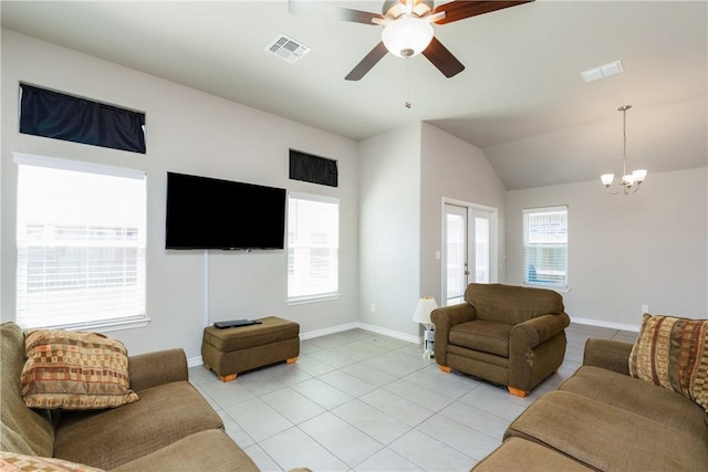 living room featuring light tile patterned floors, visible vents, ceiling fan with notable chandelier, and lofted ceiling