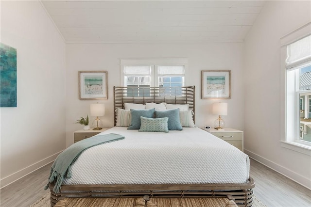 709 Sunrise Ave, Port Aransas, TX 78373 - bedroom featuring light wood-type flooring, baseboards, and vaulted ceiling