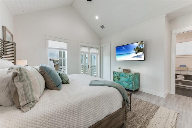 709 Sunrise Ave, Port Aransas, TX 78373 - bedroom featuring visible vents, high vaulted ceiling, baseboards, and wood finished floors
