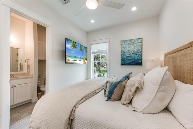 709 Sunrise Ave, Port Aransas, TX 78373 - bedroom with visible vents, connected bathroom, light wood-type flooring, recessed lighting, and a sink