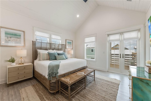 709 Sunrise Ave, Port Aransas, TX 78373 - bedroom with access to exterior, wood finished floors, baseboards, and high vaulted ceiling