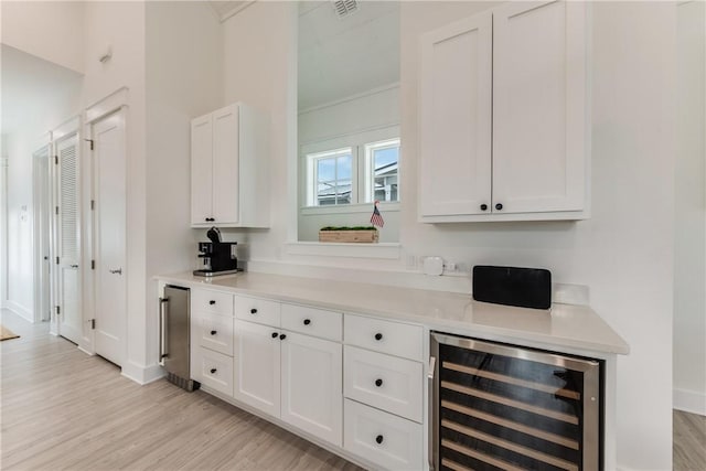 709 Sunrise Ave, Port Aransas, TX 78373 - bar featuring wine cooler, visible vents, light wood finished floors, and crown molding