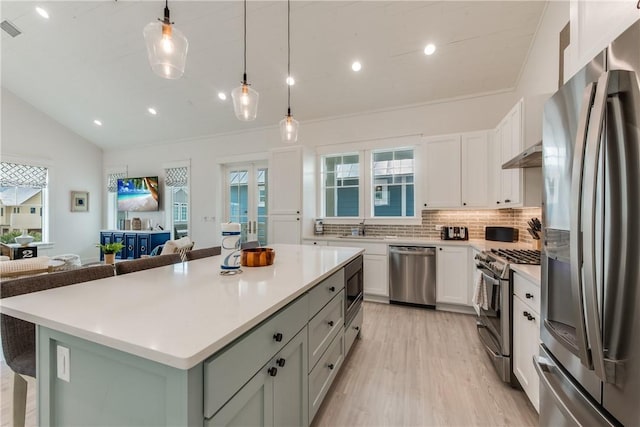709 Sunrise Ave, Port Aransas, TX 78373 - kitchen featuring open floor plan, lofted ceiling, white cabinets, stainless steel appliances, and a sink