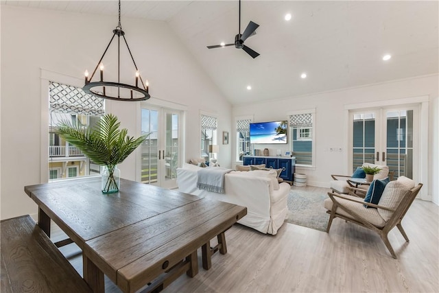 709 Sunrise Ave, Port Aransas, TX 78373 - dining area with recessed lighting, ceiling fan with notable chandelier, french doors, light wood-style flooring, and high vaulted ceiling