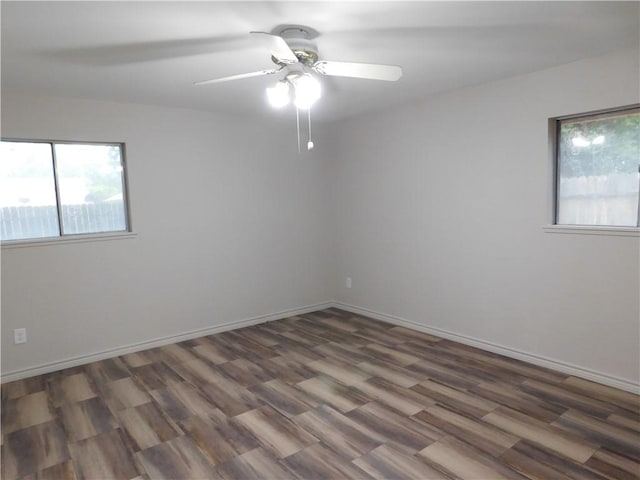 1408 Rose Dr, Alice, TX 78332 - unfurnished room with plenty of natural light, a ceiling fan, wood finished floors, and baseboards