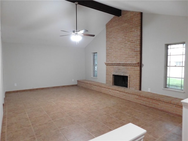 1408 Rose Dr, Alice, TX 78332 - unfurnished living room featuring plenty of natural light, ceiling fan, beamed ceiling, high vaulted ceiling, and a brick fireplace