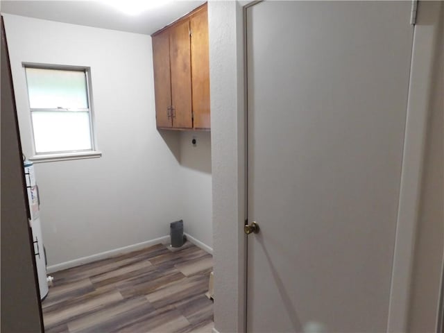 1408 Rose Dr, Alice, TX 78332 - laundry room with cabinet space, light wood-type flooring, hookup for an electric dryer, and baseboards