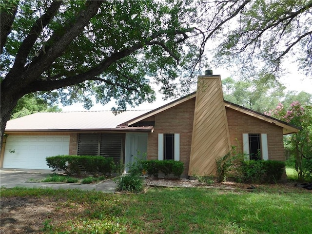 1408 Rose Dr, Alice, TX 78332 - view of front of house with brick siding, an attached garage, a chimney, and driveway