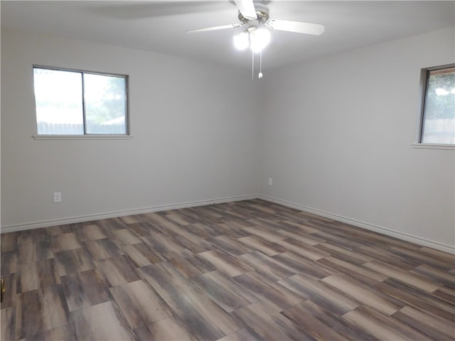 spare room featuring dark hardwood / wood-style flooring and ceiling fan