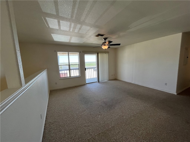 carpeted spare room featuring ceiling fan