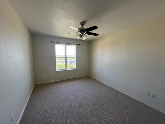 carpeted empty room featuring ceiling fan and a textured ceiling