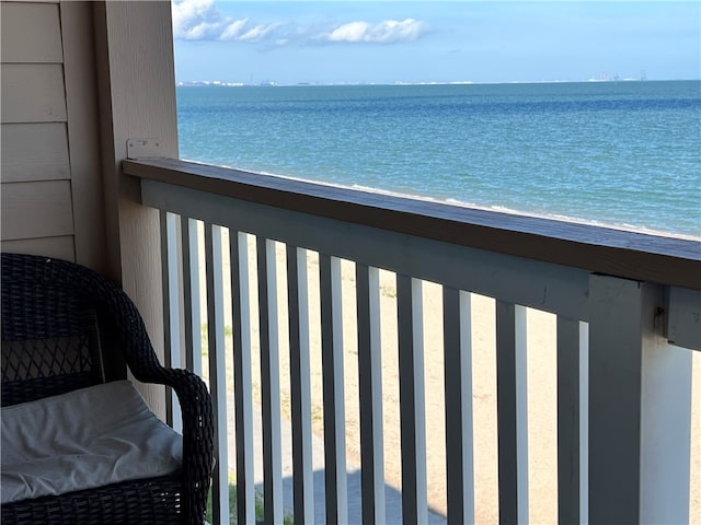 balcony featuring a beach view and a water view