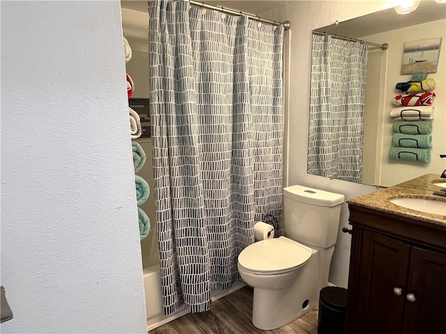 full bathroom featuring toilet, shower / tub combo with curtain, vanity, and wood-type flooring